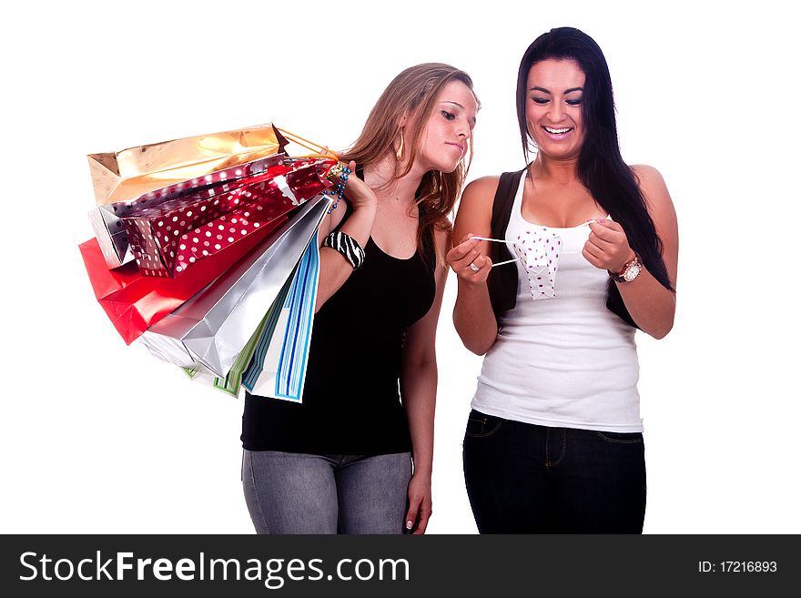 Two girls holding shopping bags, one happy and the other disappointed, on a white background. Two girls holding shopping bags, one happy and the other disappointed, on a white background.