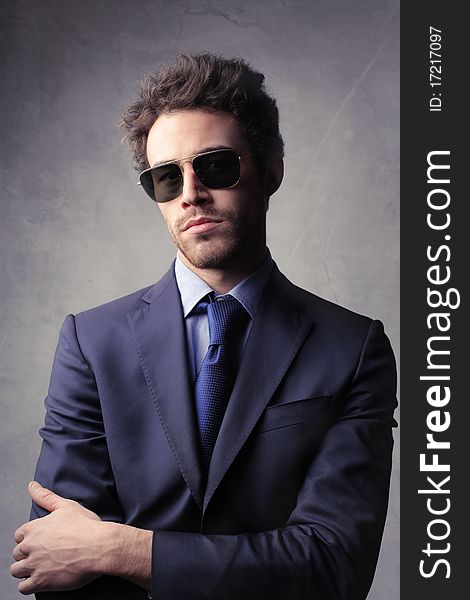 Young elegant businessman wearing sunglasses. Young elegant businessman wearing sunglasses