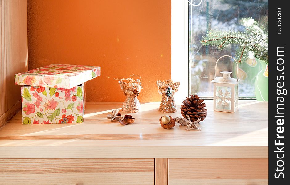 Tow angels and christmas decoration in interior near the window. Tow angels and christmas decoration in interior near the window