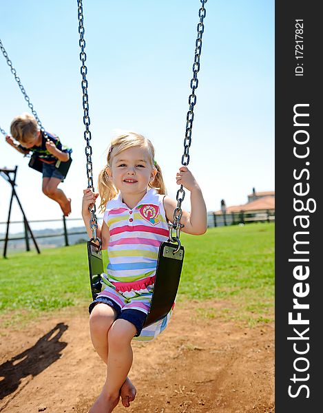 Young child on swing in playground outdoors