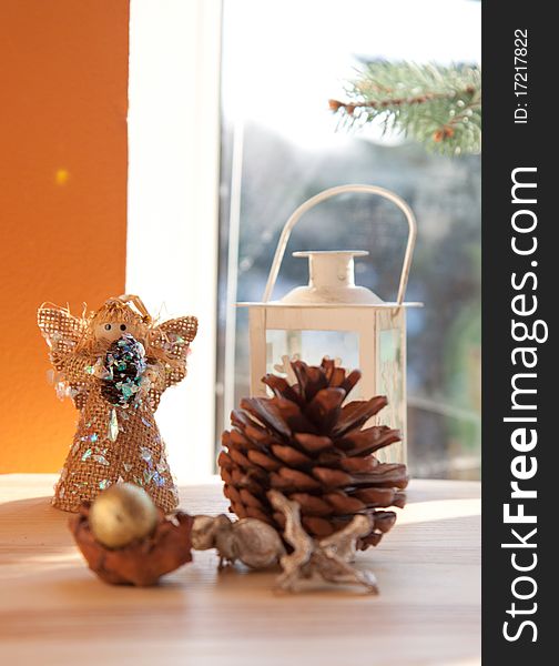 Angel and christmas decoration in interior near the window. Angel and christmas decoration in interior near the window