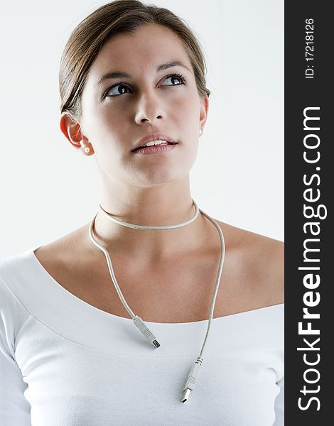 Woman wearing computer cable as necklace. Concepts: thinking only about work.