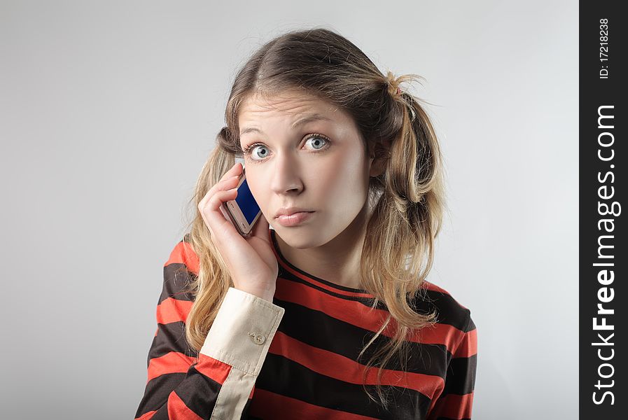 Young woman with amazed expression talking to telephone. Young woman with amazed expression talking to telephone