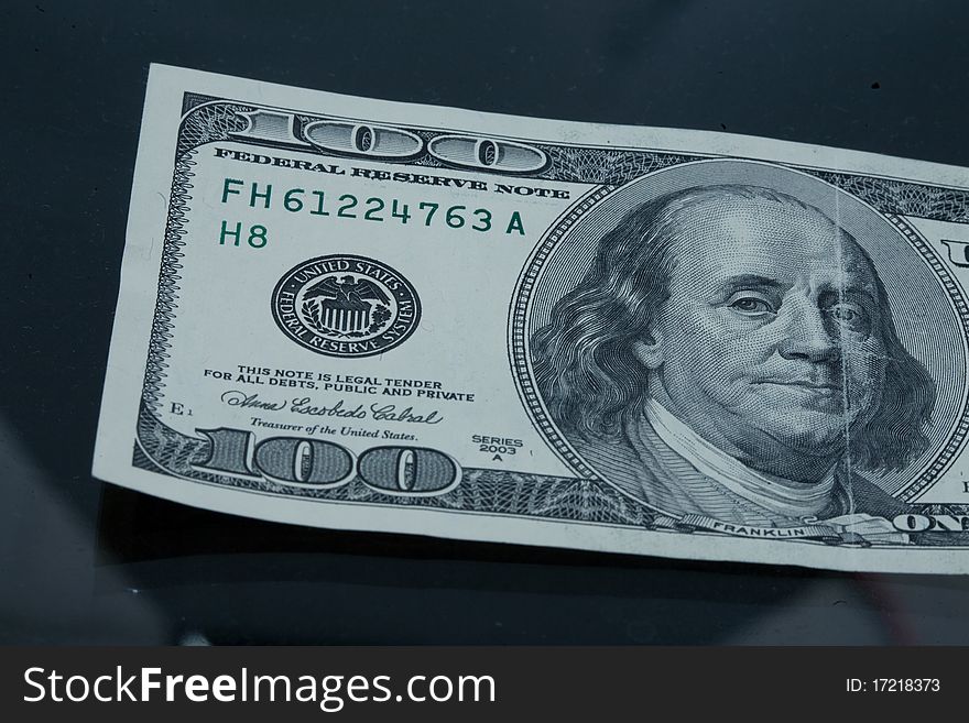 Close up of one hundered dollars on dark background