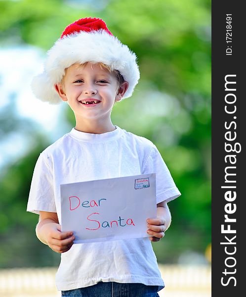 Young child holds letter for Santa Claus. Young child holds letter for Santa Claus