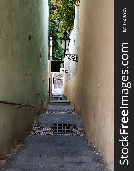 The narrow street in Prague with the steps overlooking the park