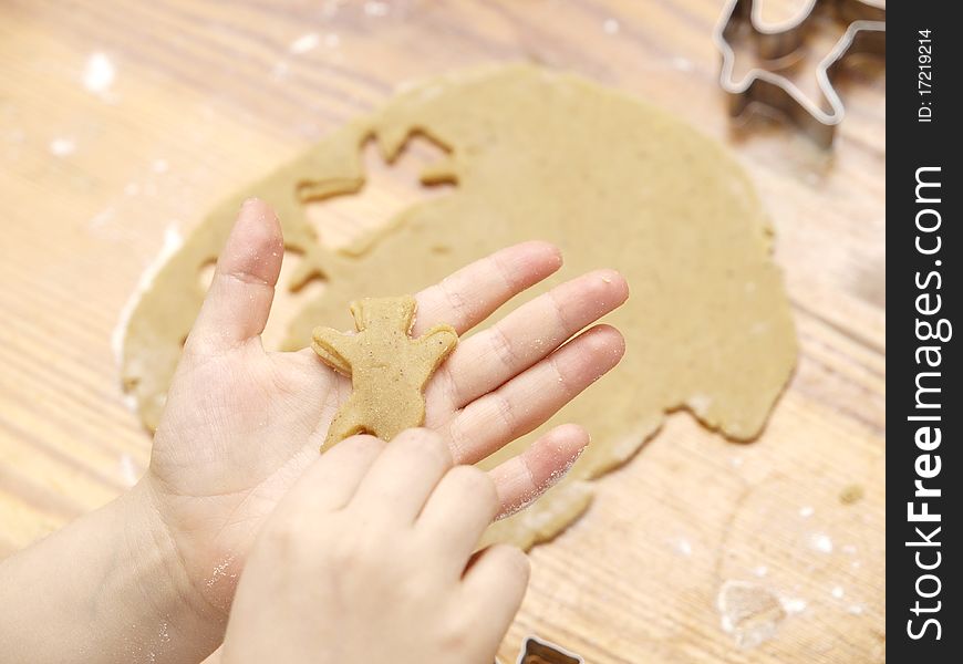 ChildÂ´s hand baking christmas cookies. ChildÂ´s hand baking christmas cookies