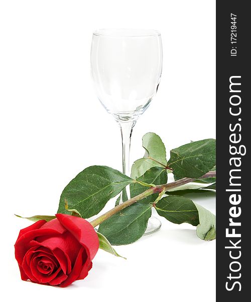 Red rose and a glass cup on a white background