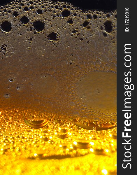 Macro shot of light beer with froth. Macro shot of light beer with froth.