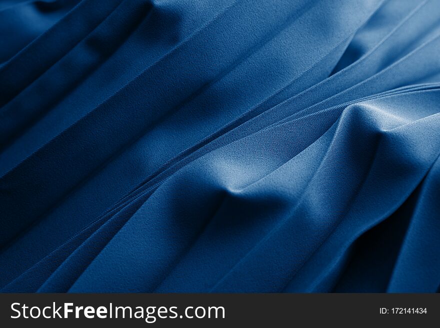 Blue Silk Or Satinfolded Fabric. Luxurious Fabric Cloth Gathers Glamour Background. Dark Blue Elegant Silk Background Use For