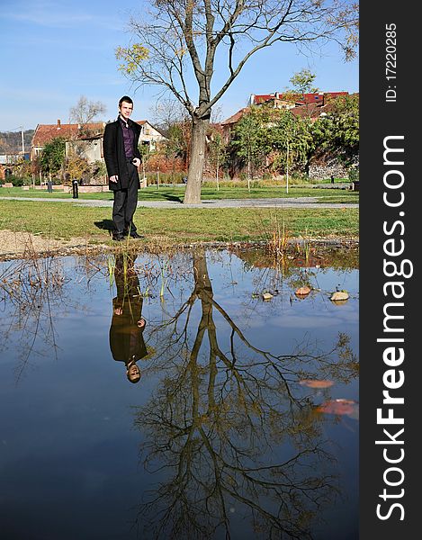 Portrait of an attractive man reflected in the lake. Portrait of an attractive man reflected in the lake