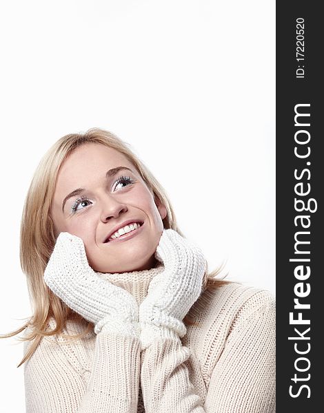 Attractive girl looks up in mittens on a white background. Attractive girl looks up in mittens on a white background