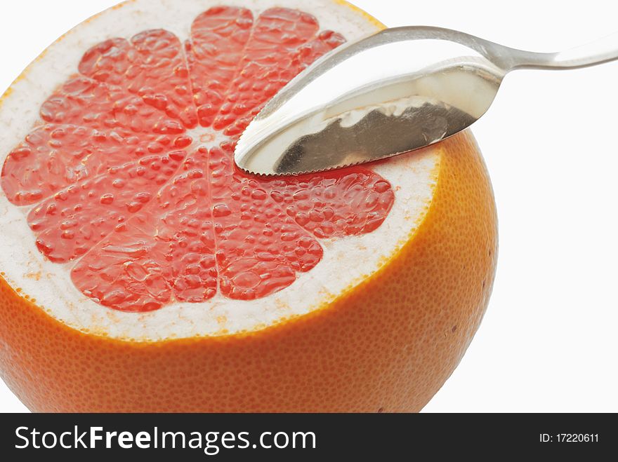 Grapefruit and spoon over white. Grapefruit and spoon over white