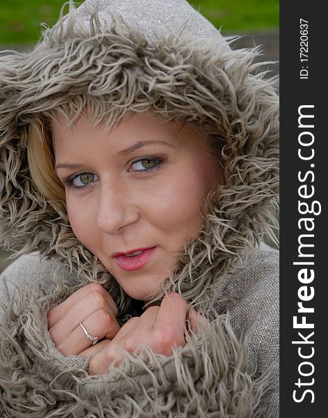 Image showing beautiful young female in warm coat and hood outdoors. Image showing beautiful young female in warm coat and hood outdoors