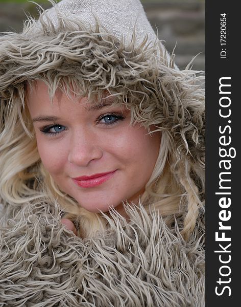 Image showing beautiful young female in warm coat and hood outdoors. Image showing beautiful young female in warm coat and hood outdoors