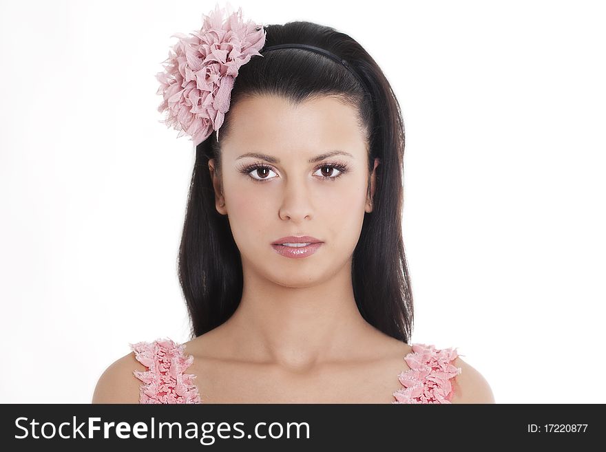 Portrait of young woman in pink dress smiling against white background