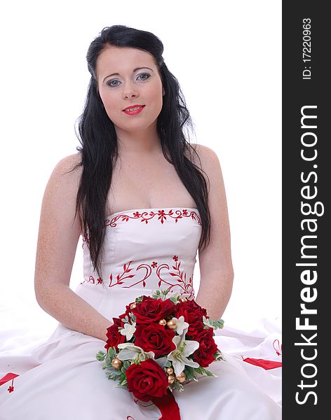 Photograph showing cute young bride in white and red wedding dress isolated against white