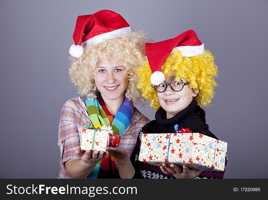 Two Beautiful Girls With Gifts In Christmas Hats