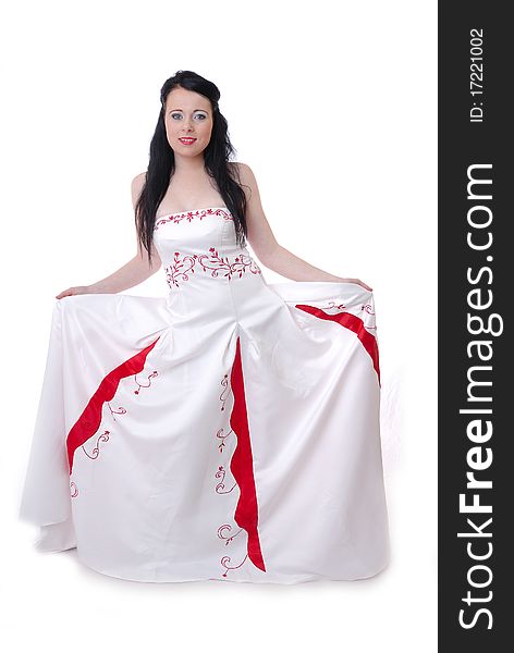 Photograph showing cute young bride in white and red wedding dress isolated against white