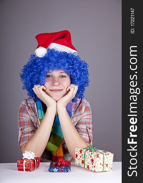 Funny girl with christmas gift. Studio shot.