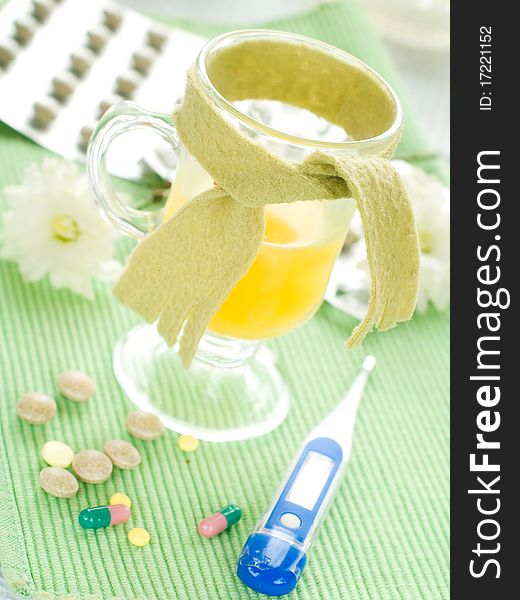 Hot drink with thermometer and pills