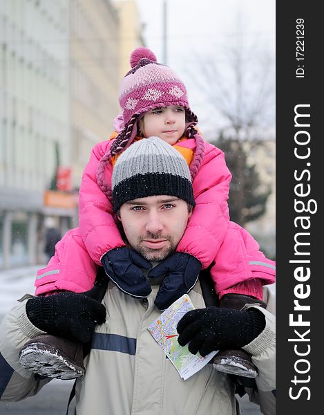 Young father gives his daughter a ride on his back