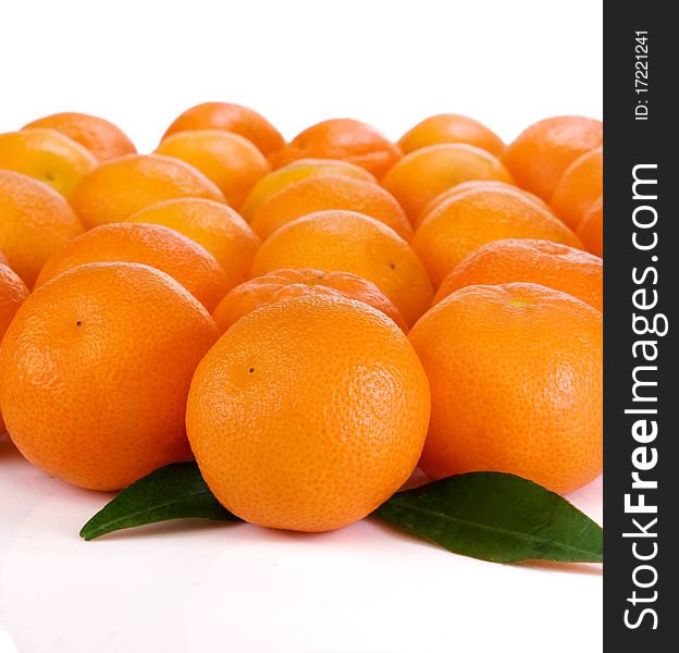 Oranges and green leaves isolated on white background