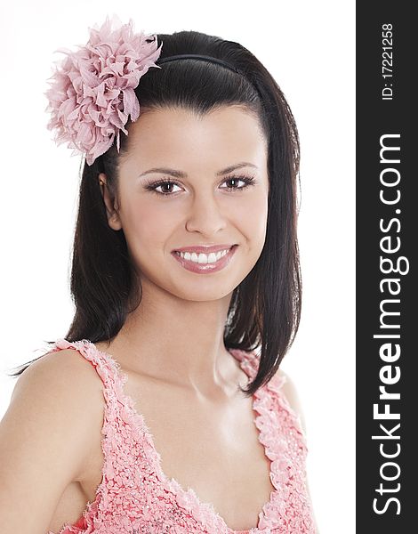 Portrait of young woman in pink dress smiling against white background