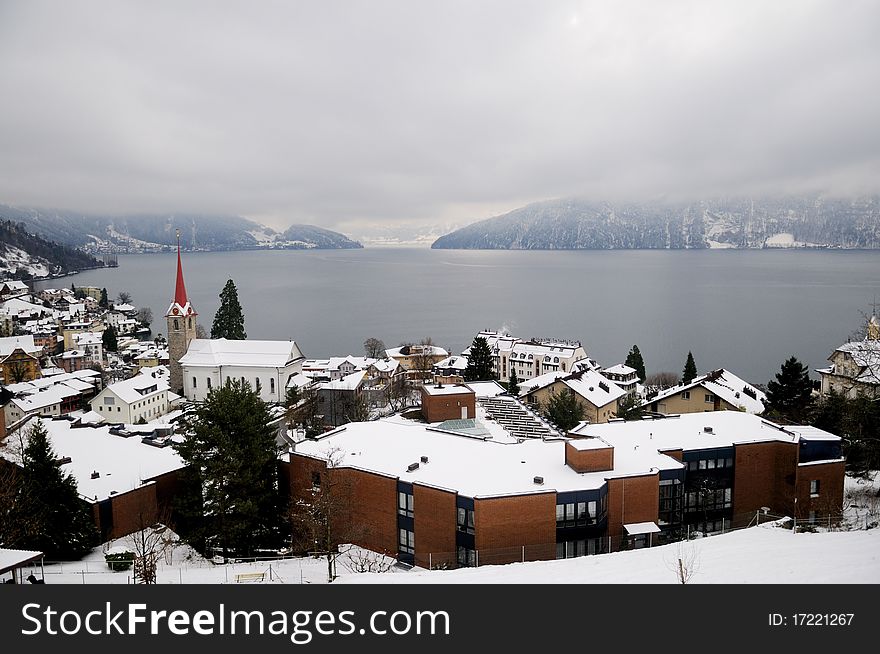 Winter view of small town and mountain lake in Switzerland