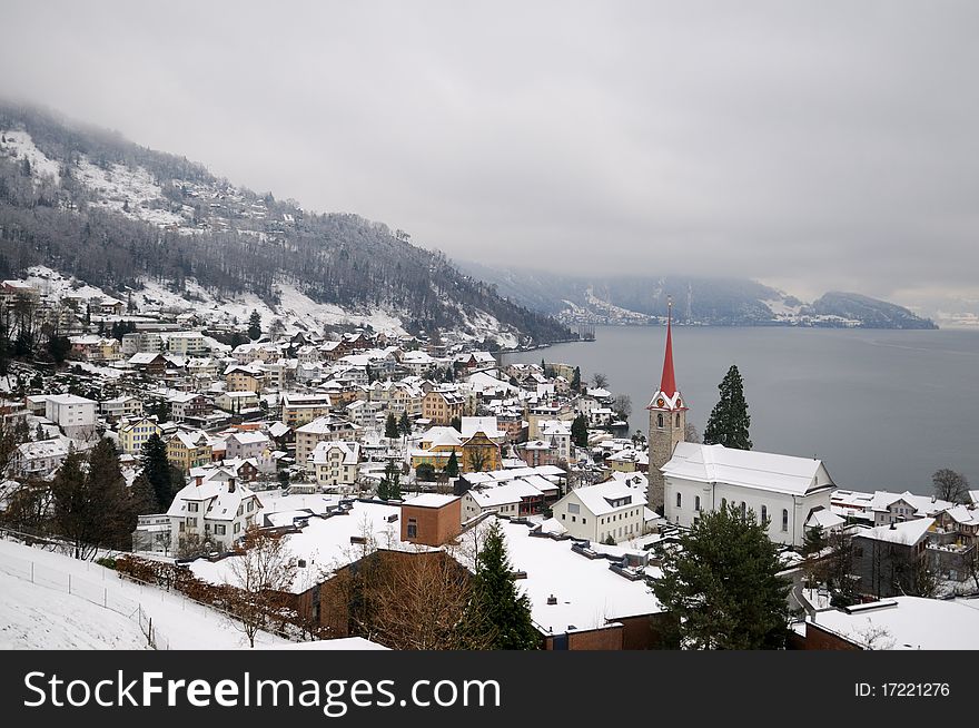 Winter view of small town and mountain lake in Switzerland