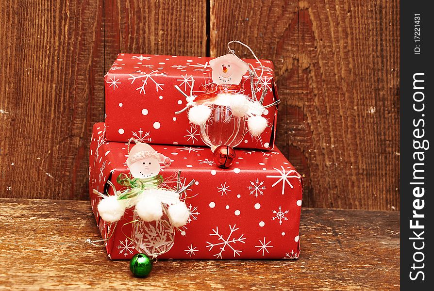 Snowman and gift boxes on wood background. Snowman and gift boxes on wood background