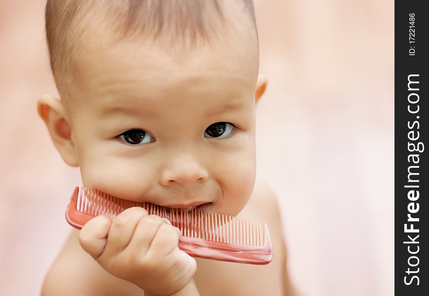 A small child learns to comb hair brush for hair