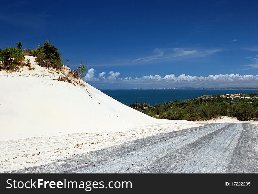 The empty road to the coast in white desert. The empty road to the coast in white desert