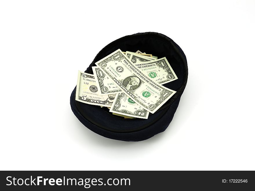 Dollars in a cap on a white background. Dollars in a cap on a white background.