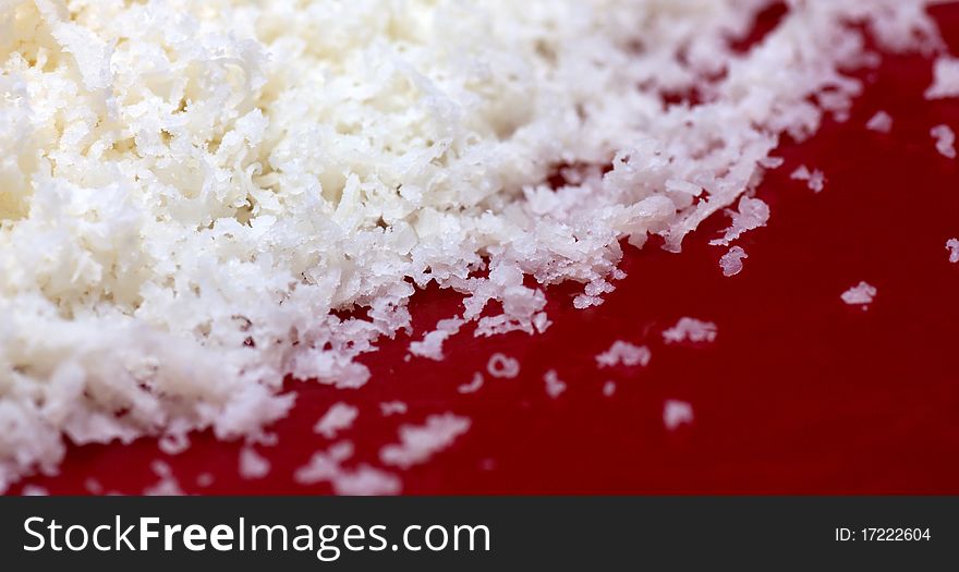 Parmesan cheese on red background