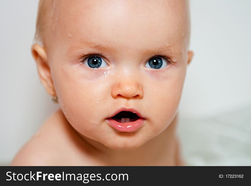 Portrait of cute baby in a bath.