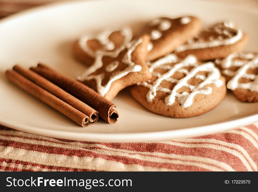 Plate of decorated cookies and sticks of the cinnamon. Plate of decorated cookies and sticks of the cinnamon