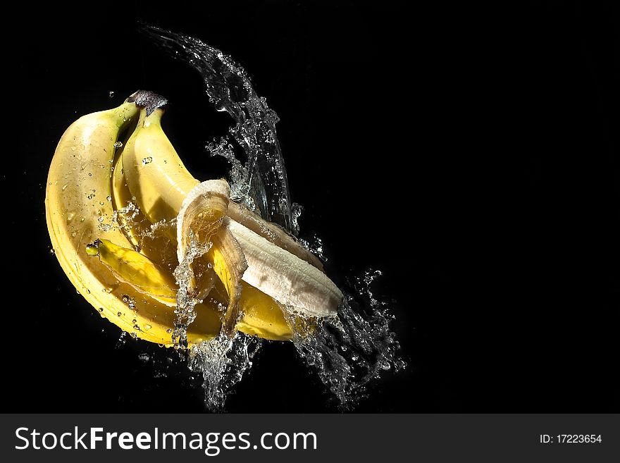 Water splashes surrounding bananas isolated. Water splashes surrounding bananas isolated