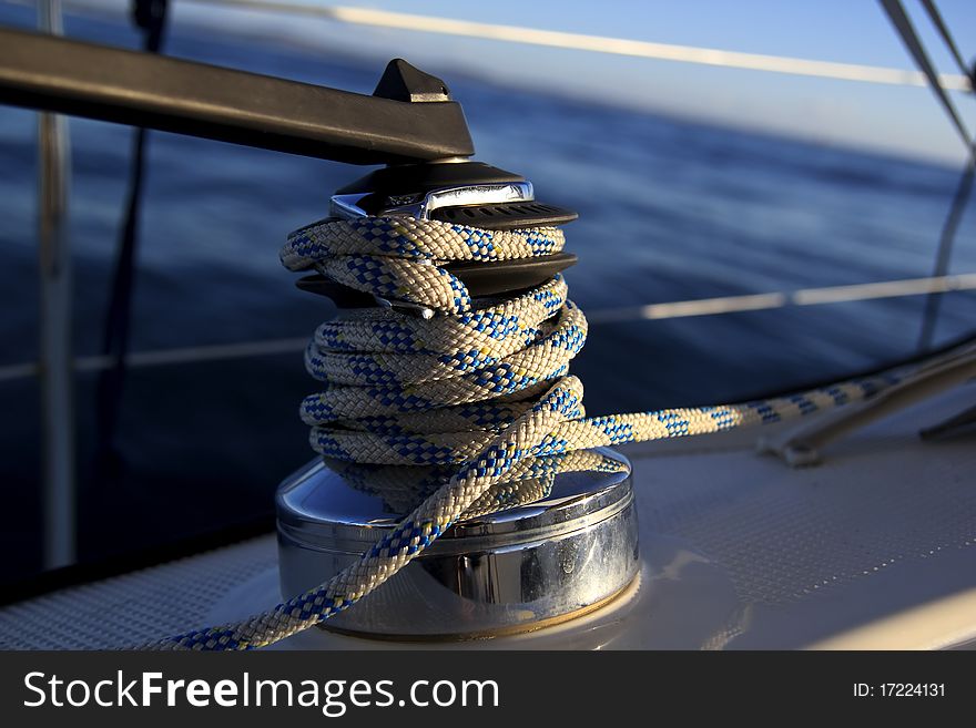 A sailboat winch and a blue ocean