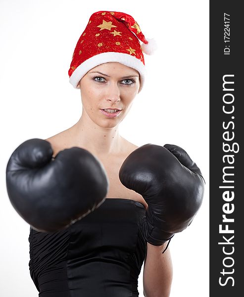 Young girl in Santa Claus hat with boxing gloves. Young girl in Santa Claus hat with boxing gloves