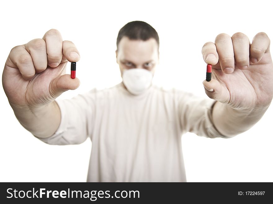 Man with hospita mask holding pills