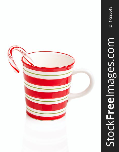 Red striped Christmas cup with candy cane isolated ona white background