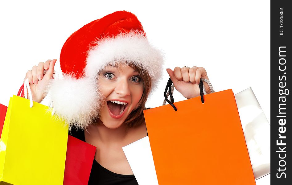 Christmas woman holding shopping bags wearing Santa hat. Isolated on white background. Christmas woman holding shopping bags wearing Santa hat. Isolated on white background.