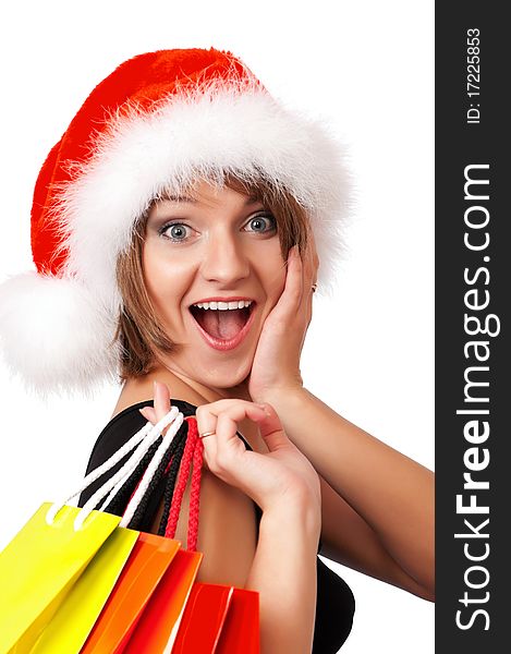 Christmas woman holding shopping bags wearing Santa hat. Isolated on white background. Christmas woman holding shopping bags wearing Santa hat. Isolated on white background.