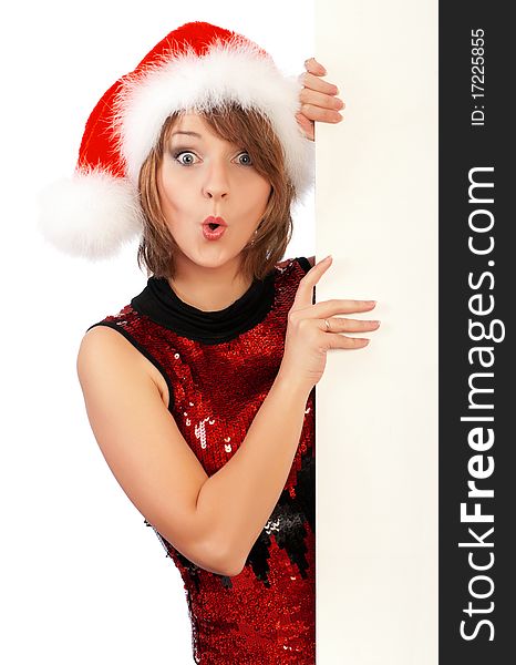 Emotional beautiful christmas girl wearing Santa hat, holding a white blank. Isolated on white background.