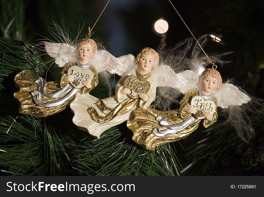 A set of three angels hanging on a tree. A set of three angels hanging on a tree.