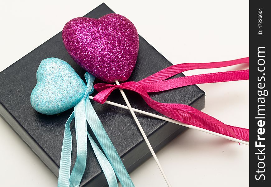 Pink and blue hearts on a black gift box