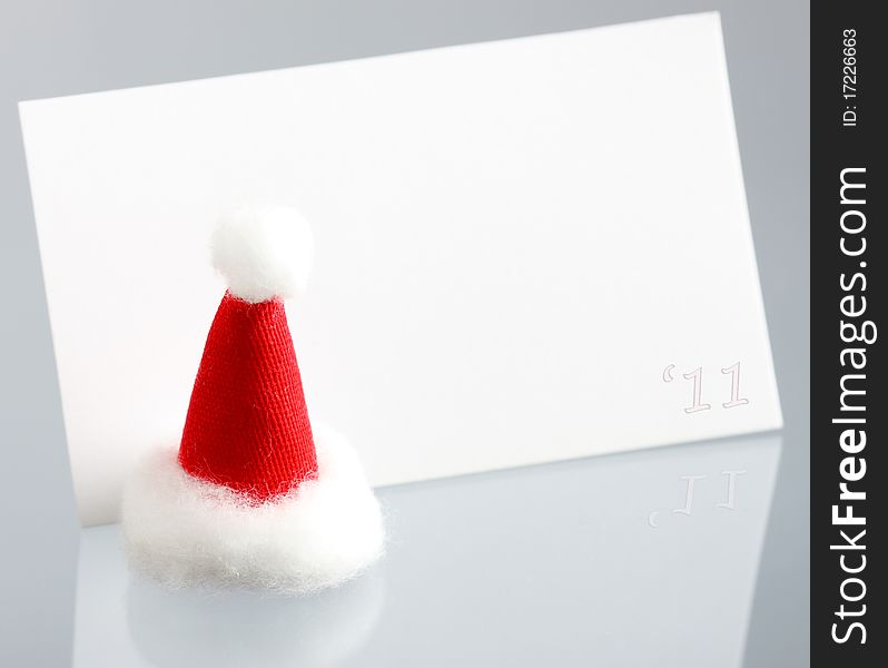 Clear New Year Card And Hat Of Santa Claus