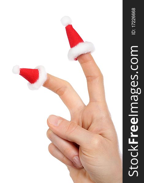 A hand with small Santas caps on fingers isolated on white