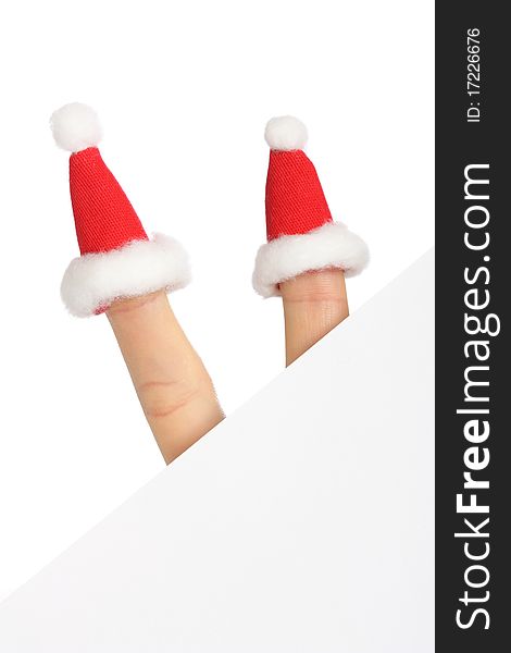 Clear sheet of paper with two fingers in small Santas caps isolated on white, copy space. Clear sheet of paper with two fingers in small Santas caps isolated on white, copy space